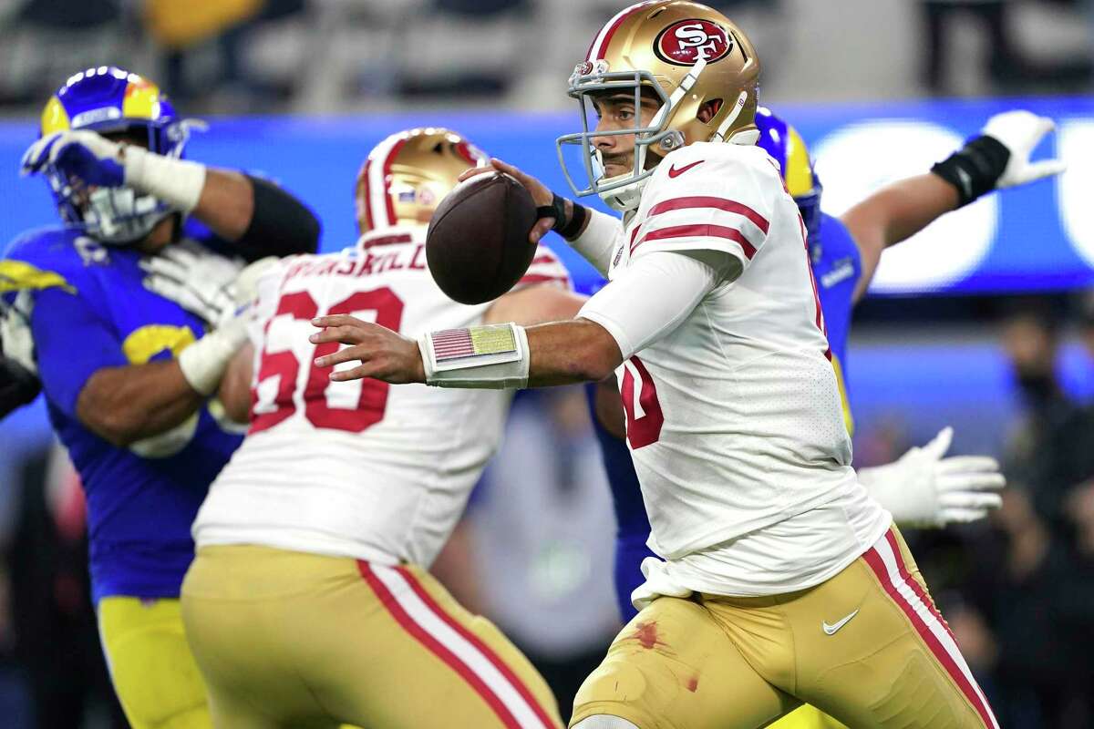 San Francisco 49ers quarterback Jimmy Garoppolo (10) looks to pass while scrambling against the Los Angeles Rams during the NFL NFC Championship game, Sunday, Jan. 30, 2022 in Inglewood, Calif. The Rams defeated the 49ers 20-17. (AP Photo/Doug Benc)