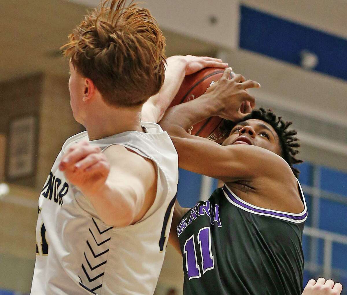 Warren guard Jaylen Randolph #11 is fouled by O’Connor Evan Whaling #11 in the first half. Warren defeated O’Connor 67-55 on Wednesday, Feb. 2, 2022