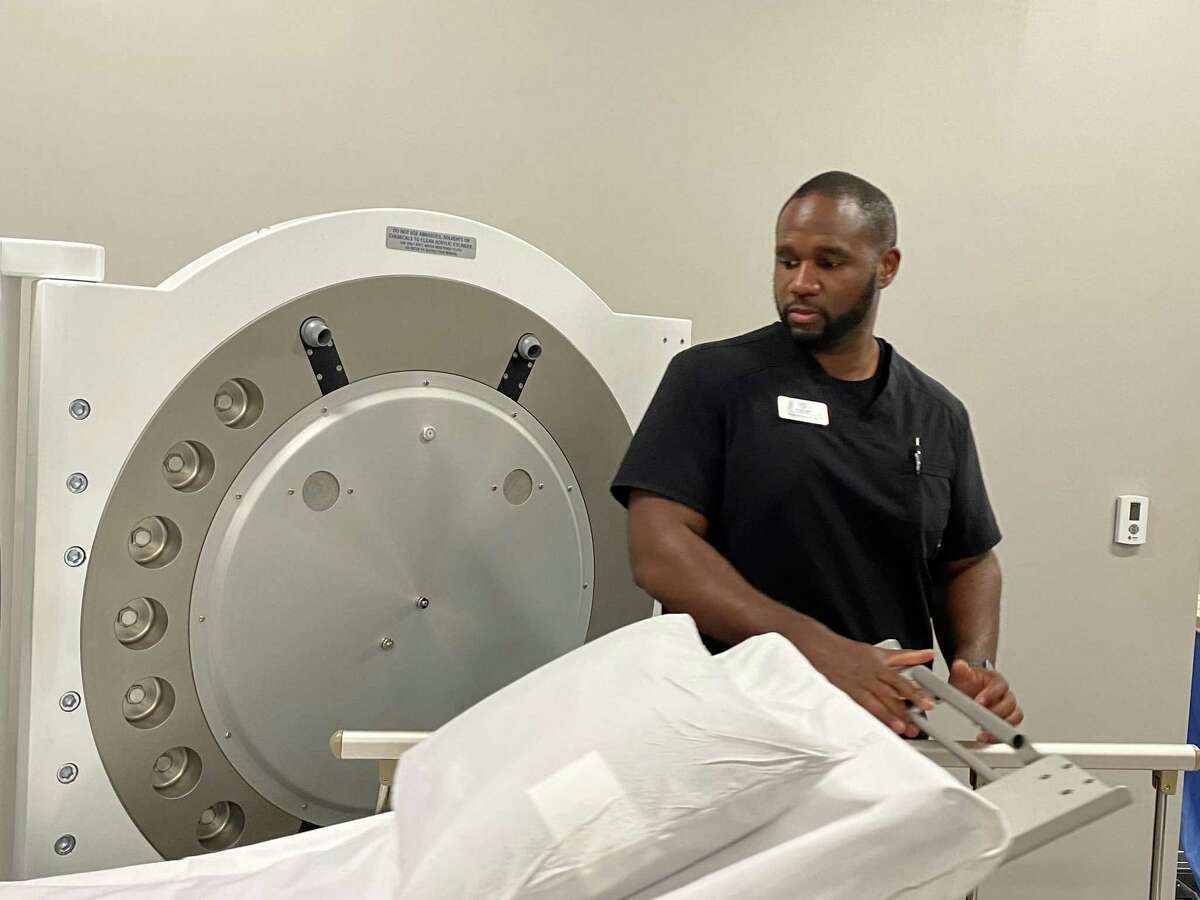 Certified hyperbaric technician Raphael Davis prepares the hyperbaric chamber to receive a patient.