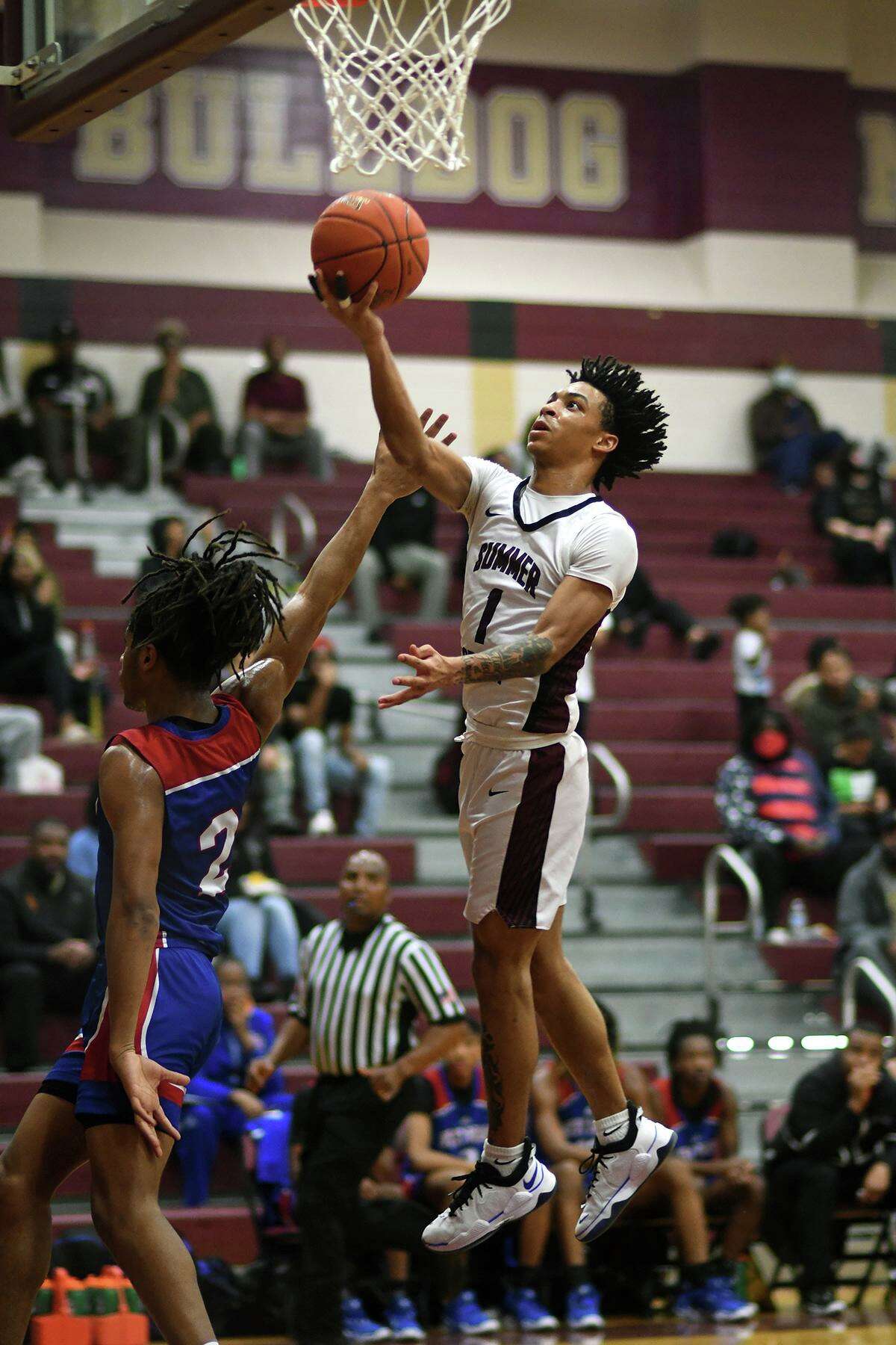 Summer Creek senior guard Jaleen Goodman (1) skies to the hoop against Beaumont West Brook sophomore guard Ashton Simmons (2) late in the second quarter of their District 21-6A matchiup at SCHS on Feb. 2, 2022.