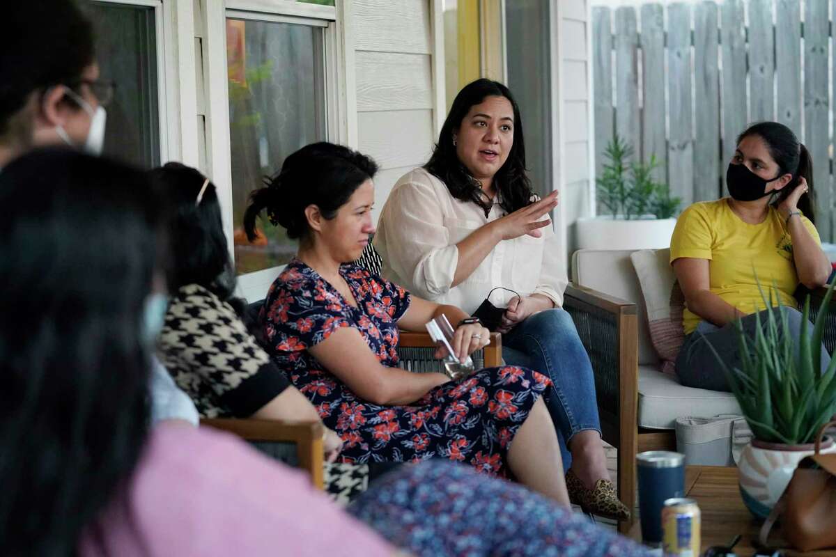 Democratic congressional candidate Rochelle Garza, second from right, holds a conversation over issues at a backyard house party in Brownsville on Sept. 24, 2021.