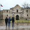 Tourist stand in front of The Alamo, closed for the day due to the weather, Thursday, Feb. 3, 2022. A strong cold front blew through the area bringing ice to most of San Antonio. Temperatures are expected to remain below freezing through Friday.