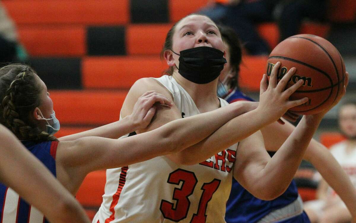 South County's Maddie Mutch is fouled on her way to the basket during a girls' basketball game against Carlinville Monday night at Franklin.