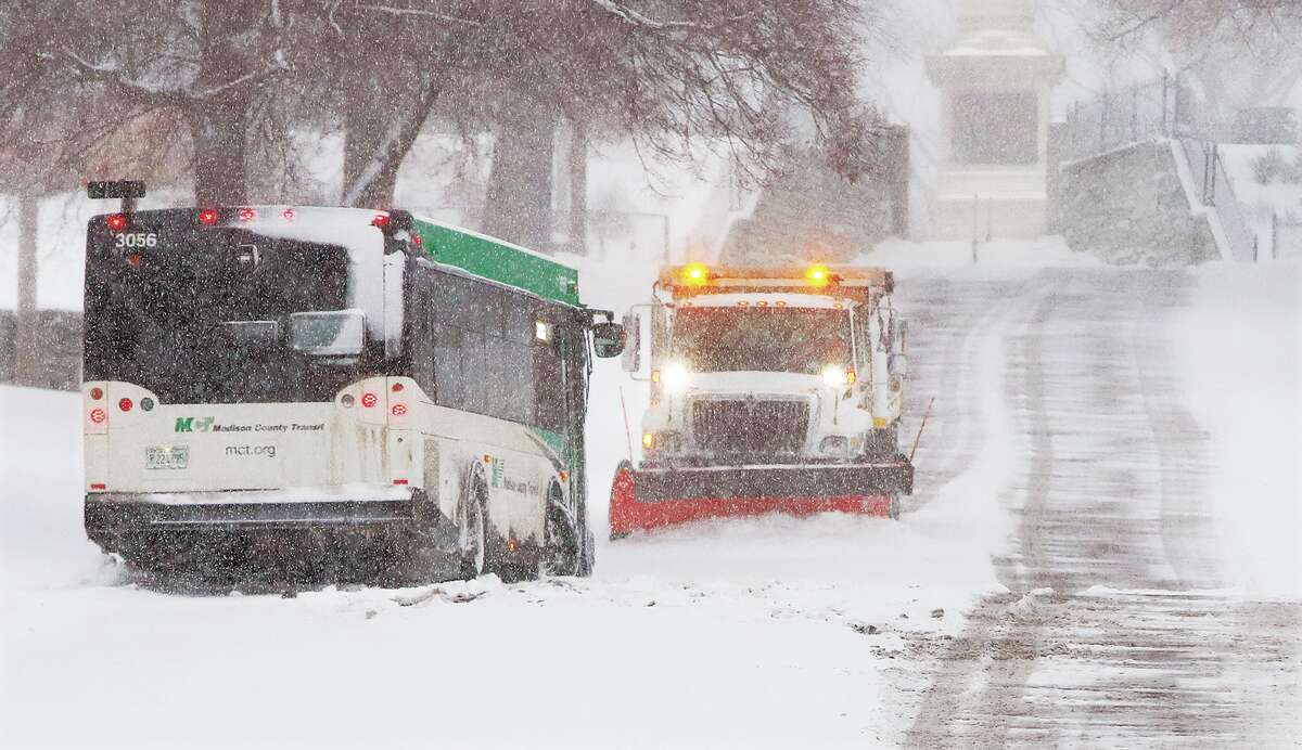 John Badman|The Telegraph An Alton city snowplow came to the rescue of a Madison County Transit bus stuck on Monument Street near Fourth Street Thursday morning.