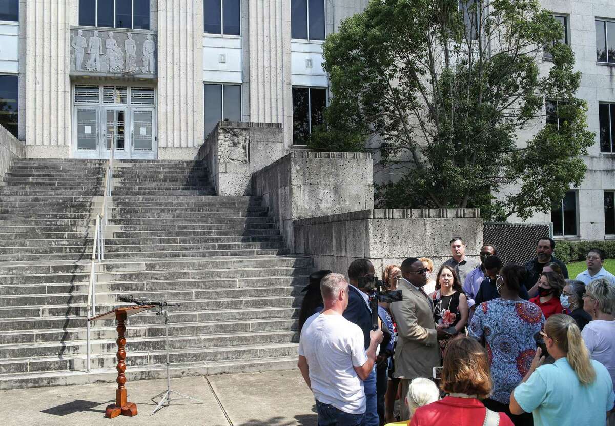 Quanell X, center in group, speaks with families before a press conference Monday, Aug. 30, 2021, at the Brazoria County Courthouse in Angleton. The Brazoria County District Attorney’s Office and Texas Rangers Public Integrity Unit are investigating allegations that the district clerk’s office, until last week led by Rhonda Barchak, improperly conducted juror selection. Families affected by the alleged misconduct gathered on the steps of the courthouse to call for a federal investigation.