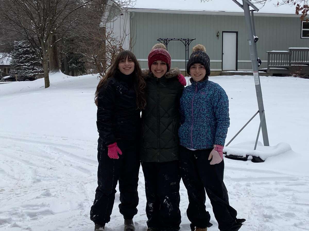 Milania Harris (left) and Isabella Harris (right), Class of 2025, with their aunt Miriah (middle), a theology teacher at Mater Dei enjoying the snow together. 