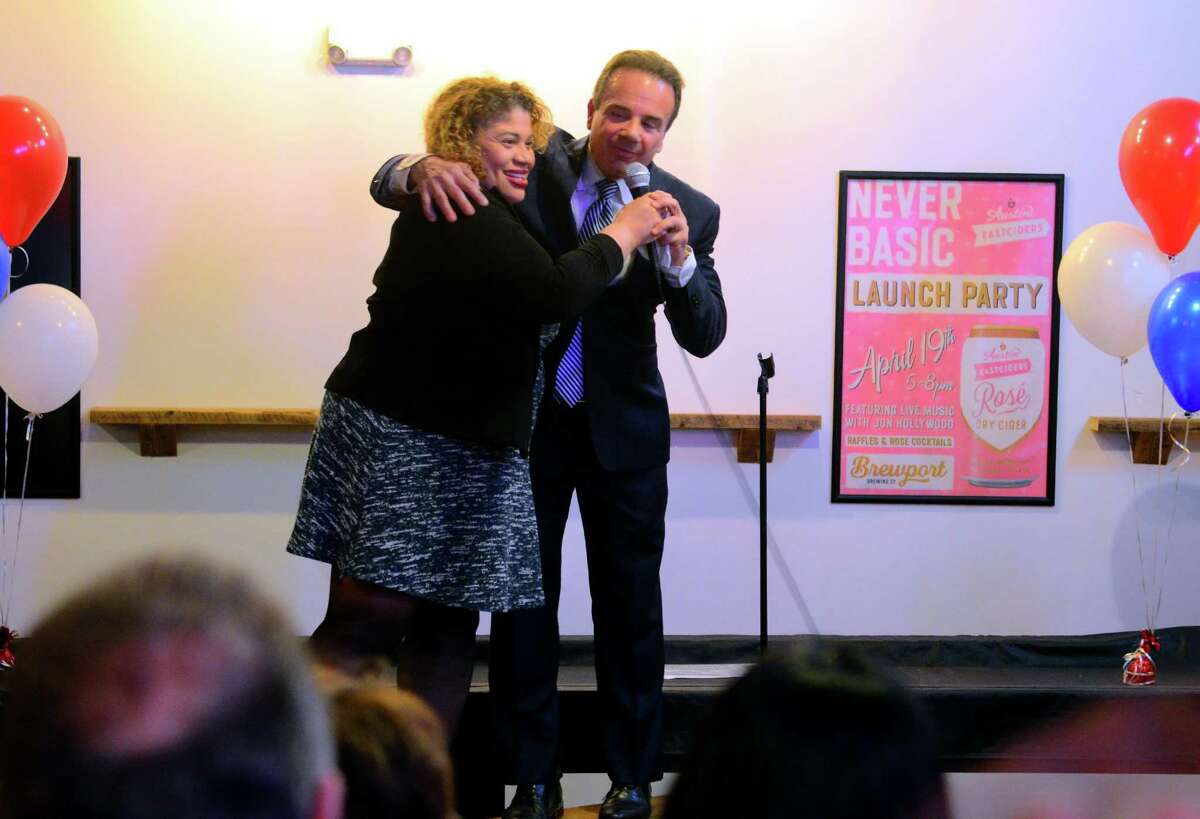 Mayor Joe Ganim hugs Bridgeport City Council President Aidee Nieves after addressing supporters at a fundraiser for his mayoral campaign at Brewport restaurant in Bridgeport, Conn., on Tuesday April 9, 2019.