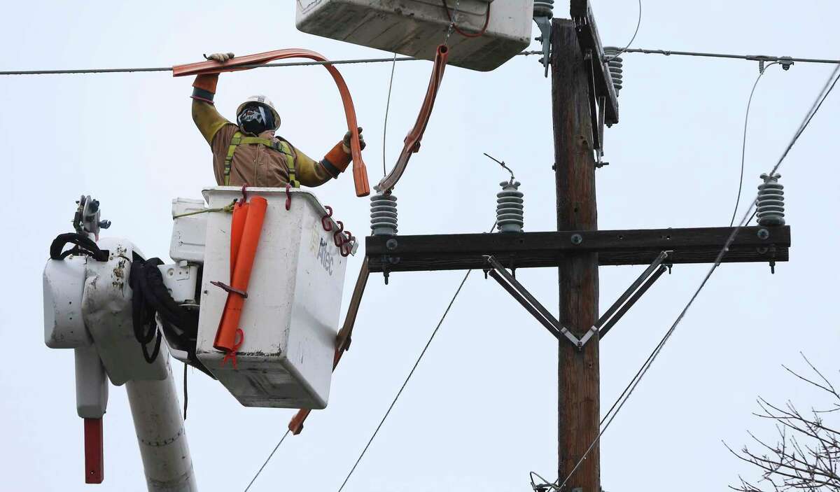 Linemen contracted by CPS Energy work on a downed line in Castle Hills as a strong cold front blows into town causing icy conditions on Thursday, Feb. 3, 2022. Several crews were in the area working to restore power to area residents.