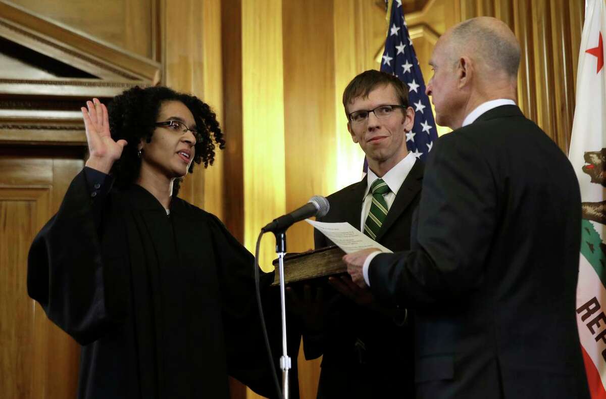 Leondra Kruger, accompanied by husband Brian Hauck, is sworn in to the California Supreme Court by then-Gov. Jerry Brown in January 2015.