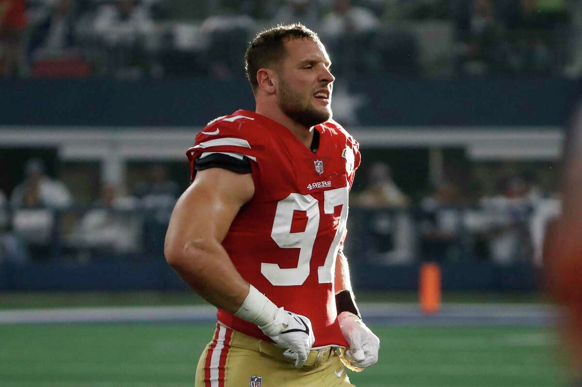 San Francisco 49ers defensive end Nick Bosa walks off the field during the first half of an NFL wild-card playoff football game against the Dallas Cowboys in Arlington, Texas, Sunday, Jan. 16, 2022. (AP Photo/Roger Steinman)