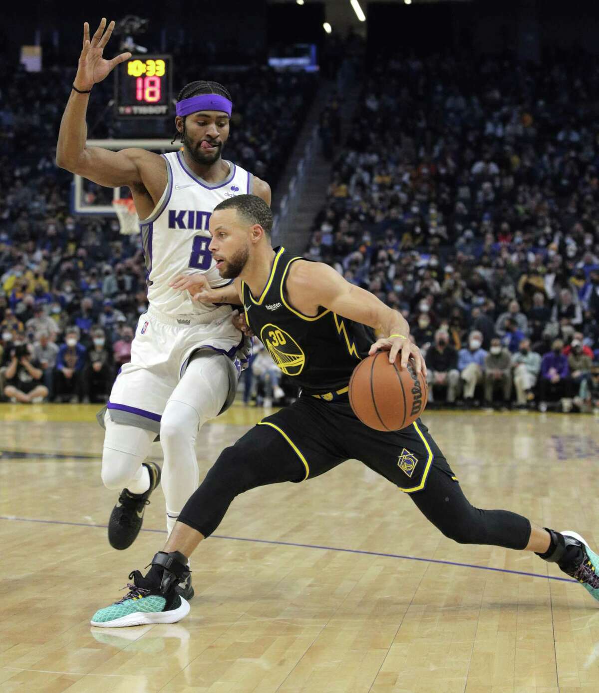 Stephen Curry (30) puts the brakes on while defended by Maurice Harkless (8) in the first half as the Golden State Warriors played the Sacramento Kings at Chase Center in San Francisco, Calif., on Thursday, February 3, 2022.