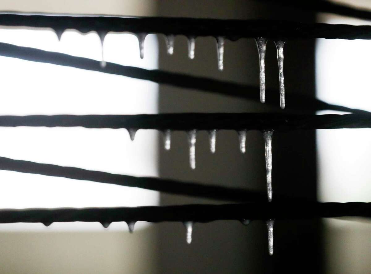 Icicles form on the steel rails in a parking garage as morning temperatures remain in the high 20s, Friday, Feb. 4, 2022, in Conroe.