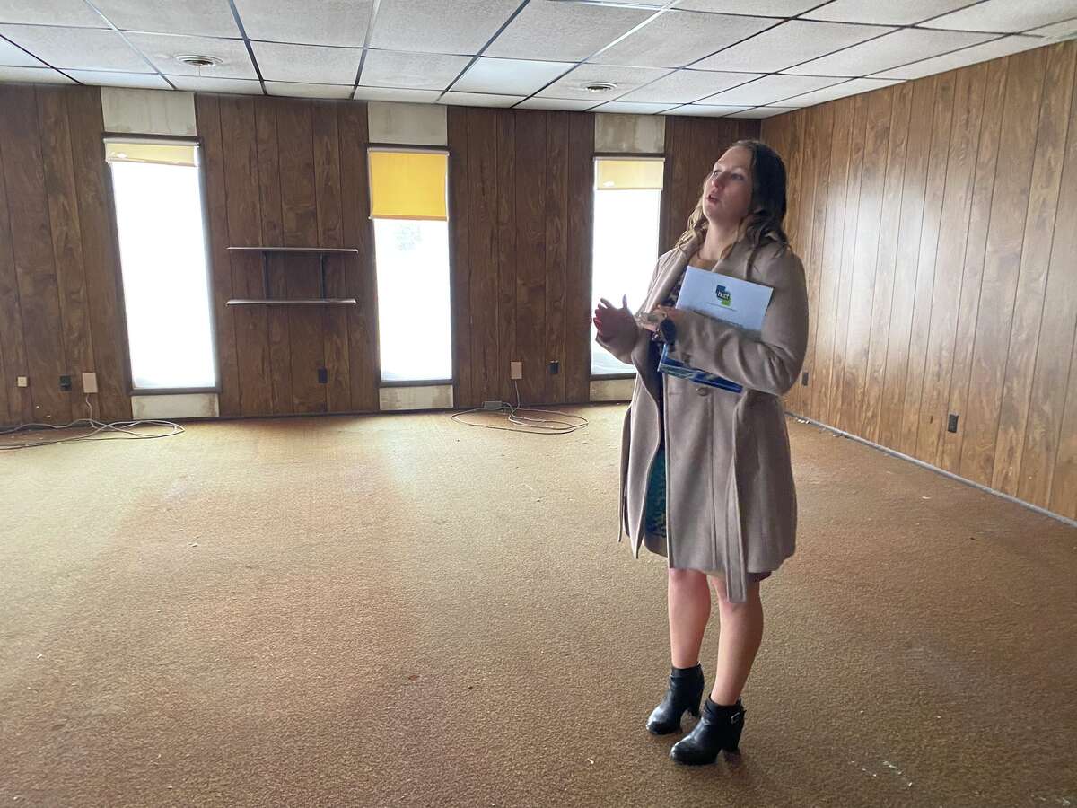 MacKenzie Price, executive director of the Huron County Community Foundation, stands in the building on Huron Avenue that will be home to the foundation's Community Hub in a 2022 file photo. The building contains remnants of its former use as a party store and gas station.