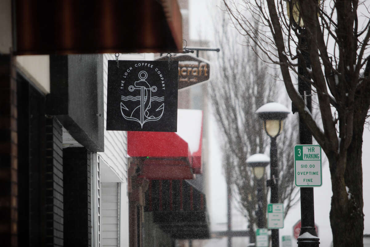The sign of the now-closed Loch Coffee Company hangs from the business on Ashman Street Wednesday, Feb. 2 in downtown Midland. Populace Coffee has announced plans to open in that location within a year.