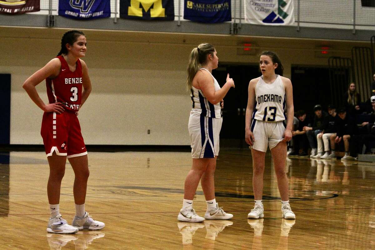 Onekama senior point guard Carly Bennett consults Hailey Hart against Benzie Central on Feb. 1.