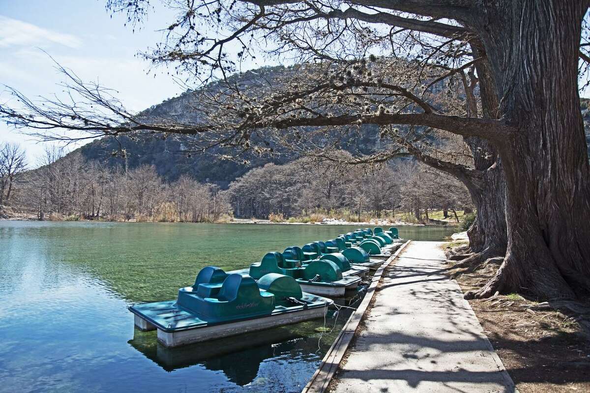 With docked paddle boats docked looking lonely in the winter months, this area of the shallow Frio River at the dam is jam-packed with youngsters, families and couples during the busy season.