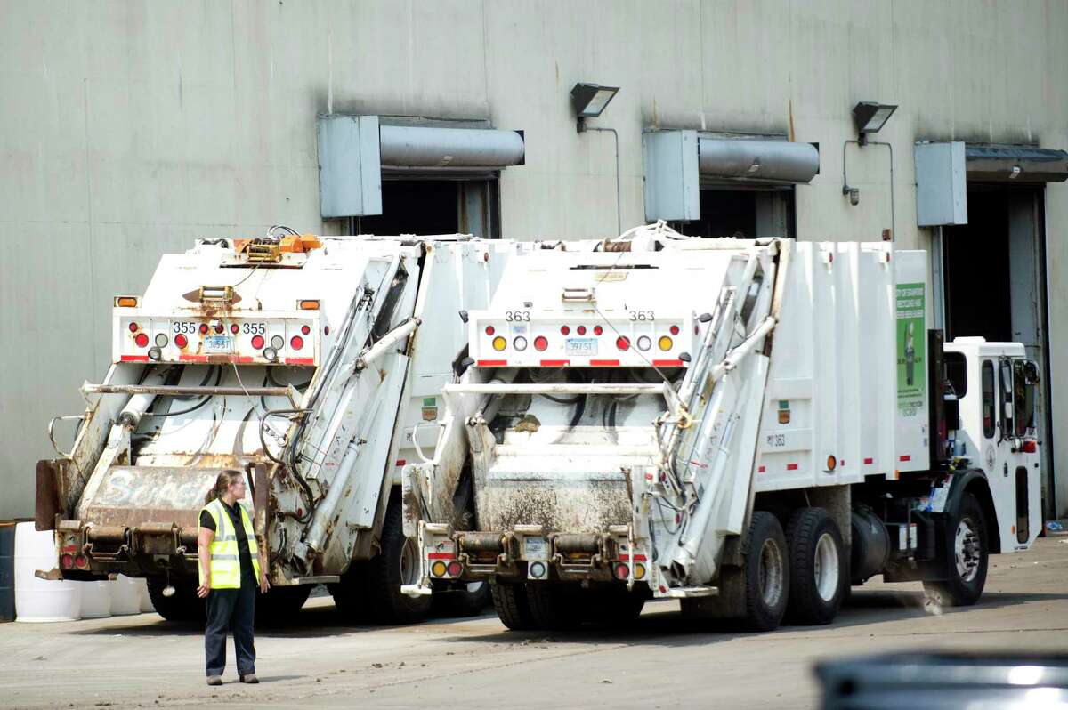 Garbage trucks sit waiting to be filled at the Stamford Transfer Station on Harborview Ave. in Stamford, Conn. on Thursday, Aug. 16, 2018.