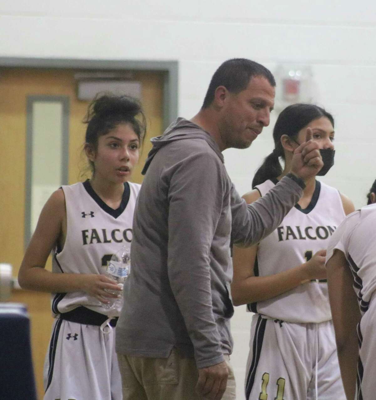 Miller 8A coach Chris Roque gives his players a breather during a timeout in the championship game with Bondy. The Lady Falcons had a very strong season, going undefeated until Tuesday night's finale.