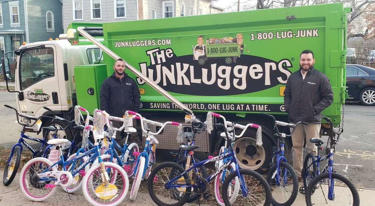 AJ Tucciarone, operations manager, left, and Gustavo Mesa, director of operations, delivering bikes from Junkluggers of Greater New Haven to Clifford Beers in December.