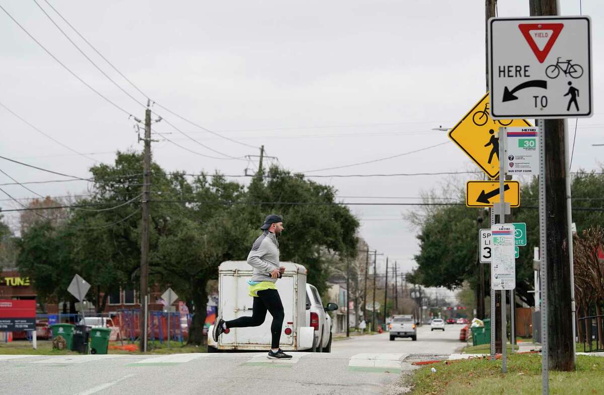 A runner crosses 11th Street at Nicholson along the Heights Hike and Bike Trail on Thursday, Feb. 3, 2022 in Houston. The crossing is considered among the most perilous along the trails within Loop 610.