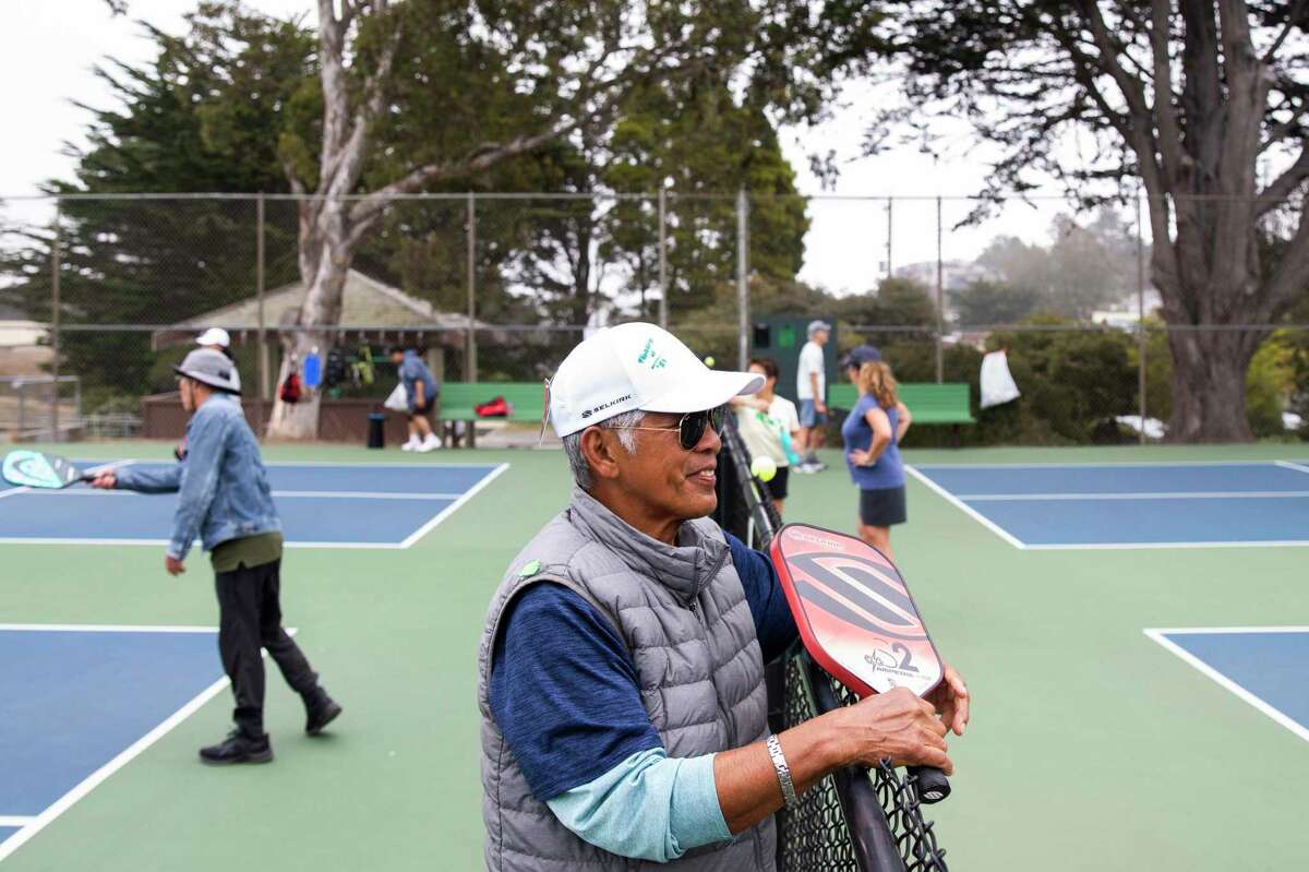 Felix Evangelista, 77, takes a break while playing pickleball at the courts near Louis Sutter Playground in McLaren Park in San Francisco in August 2021.