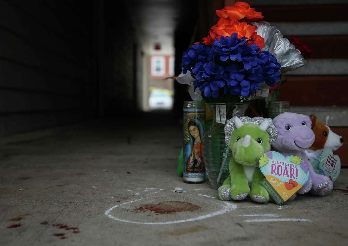 Candles, flowers, balloons and stuffed animals have been placed at the spot where an 11-year-old boy died after being shot at an apartment complex on the 12200 block of Tidwell Road on Friday, Feb. 4, 2022, in Houston.