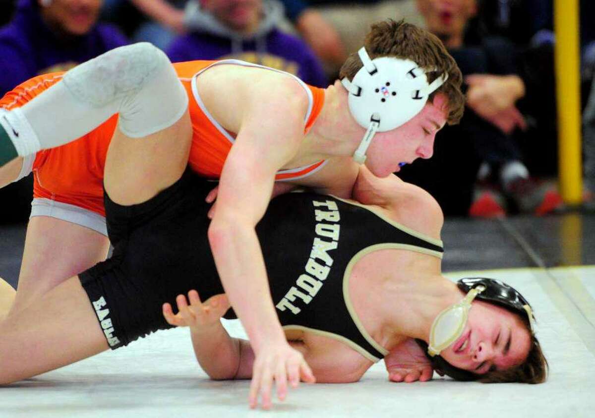 Ridgefield’s Alex Blaha, left, battles Trumbull’s Michael Longo in the 106-pound finals at the 2020 Class LL wrestling championships.