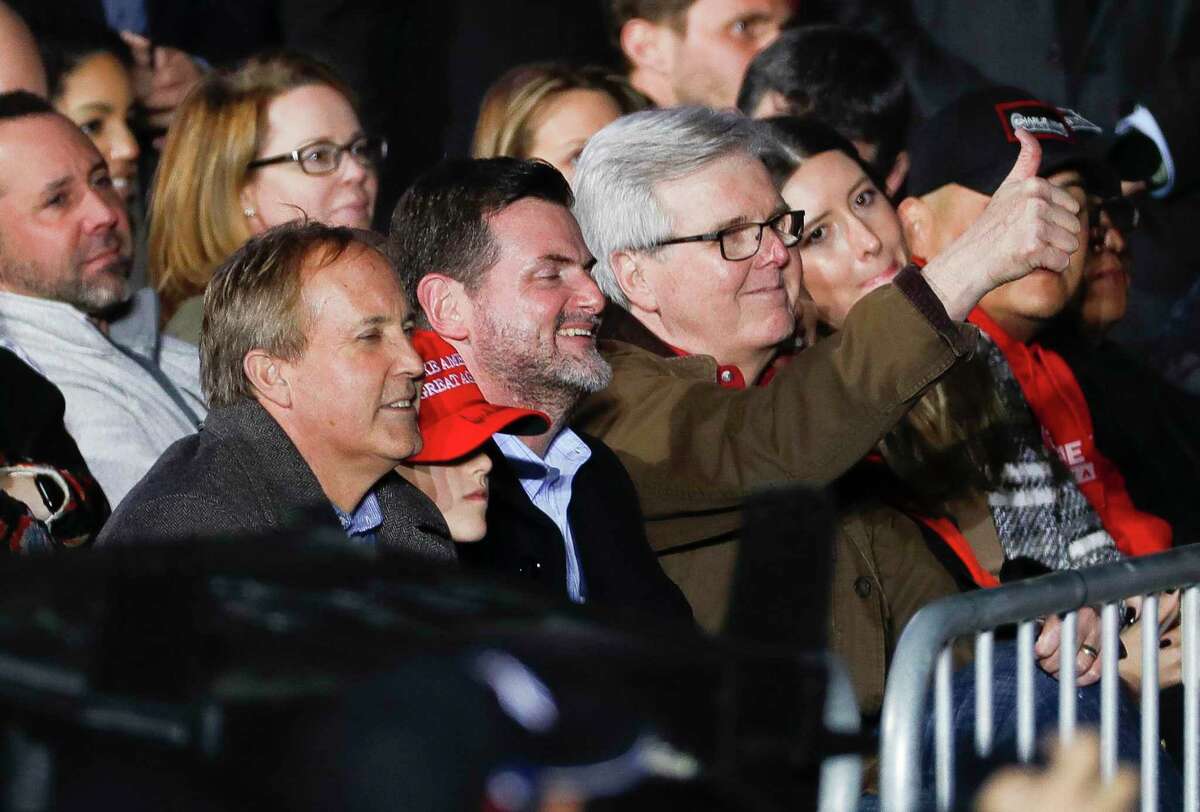 Texas Lt. Gov. Dan Patrick, right, gives a thumbs-up after former President Donald Trump mentions him beside State Sen. Brandon Creighton and Attorney Gen. Ken Paxton at a Save America Rally, Saturday, Jan. 29, 2022, in Conroe.