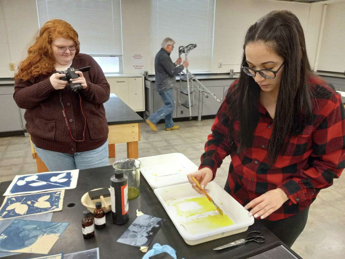 At the Five Points Arts Center at the former UConn Torrington campus, Erin Cutliffe, left, coordinator of events and membership, and administrative assistant Erika Santos, right, create pieces for a social media project.
