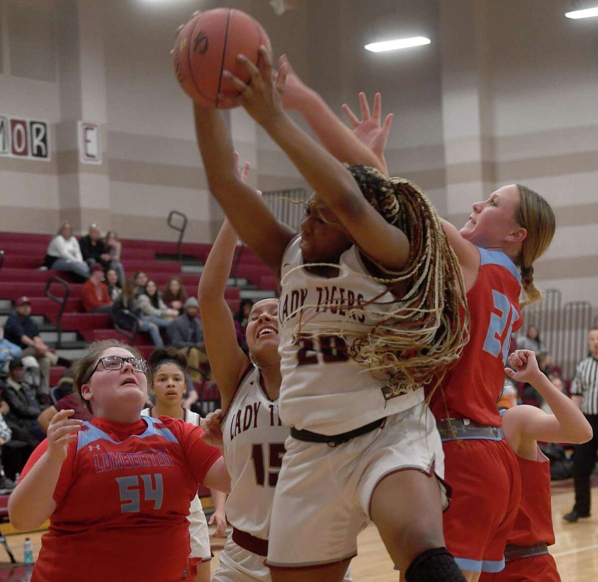 Lumberton's Maddie Catlett stands by as Reese Watkins battles with Silsbee's Jasmine Matlock and Ca'driane Martin for the rebound during Friday's game in Silsbee. Photo made Friday, Feruary 4, 2022 Kim Brent/The Enterprise