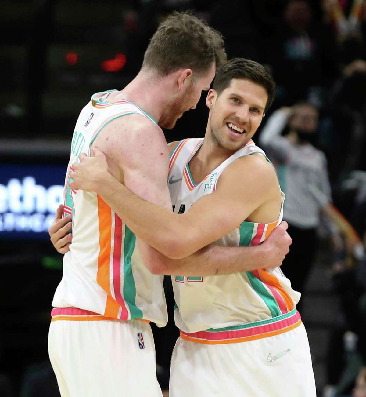 Spurs' Doug McDermott (17) gives a hug to teammate Jakob Poeltl (25) after scoring a three against the Houston Rockets in the second half at the AT&T Center on Friday, Feb. 4, 2022. Spurs defeated the Rockets, 131-106.