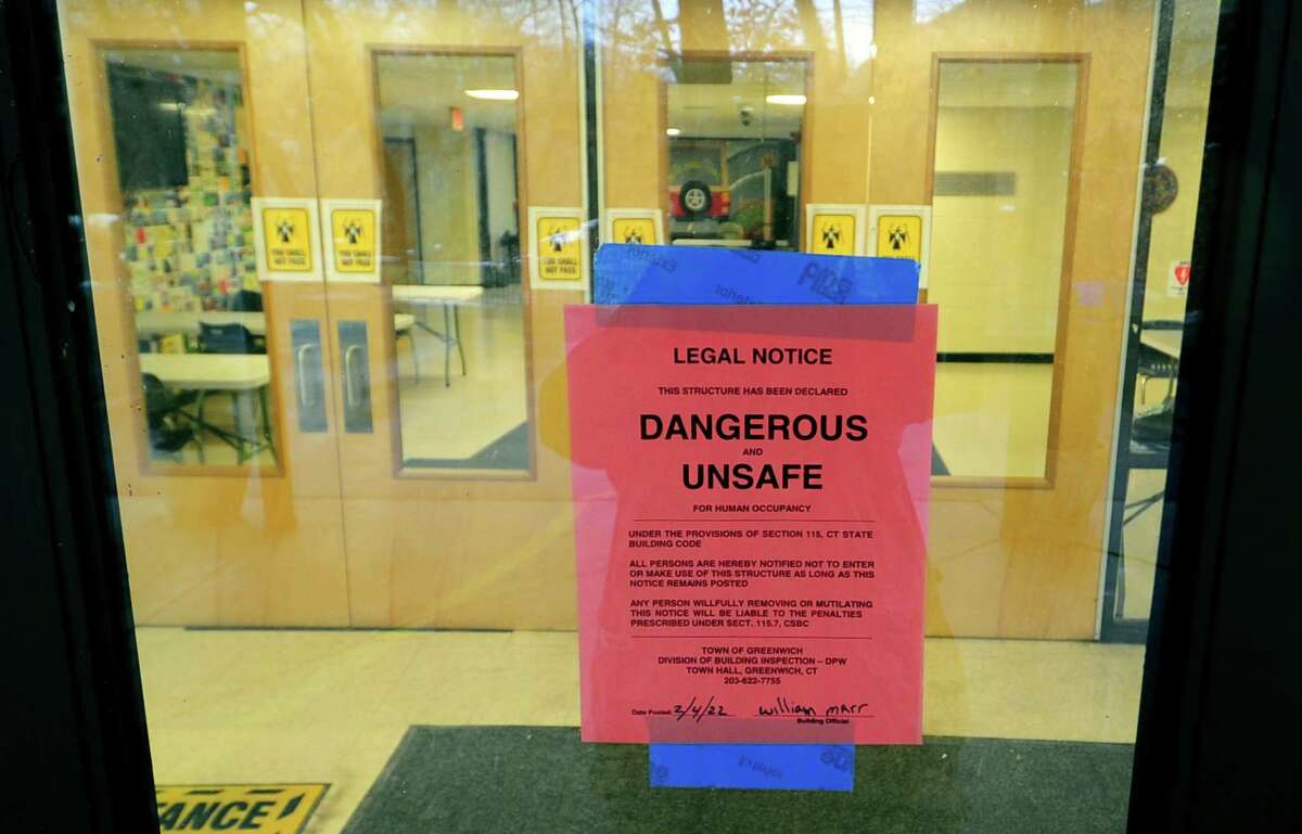 An exterior view of Central Middle School in Greenwich, Conn., on Friday, February 4, 2022. A signs says the building has been closed after the town has declared it unsafe.