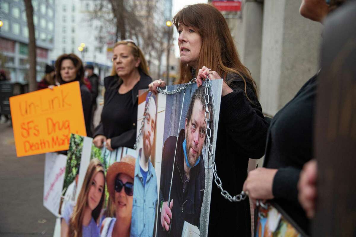 Joined by supporters, mothers affected by the drug crisis hold signs during a protest against open drug use at the S.F. Linkage Center on Saturday, Feb. 5, 2022 in San Francisco.