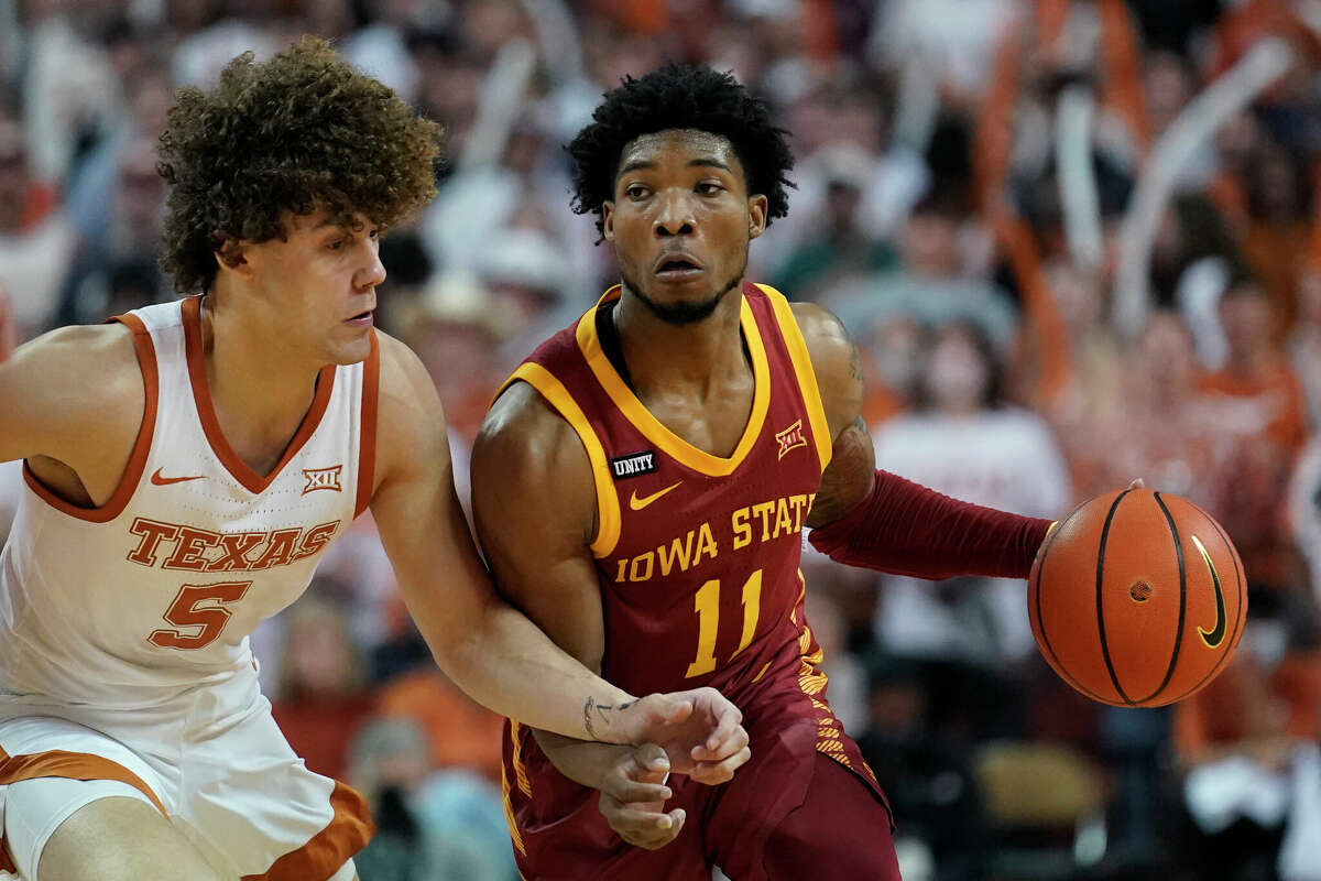 Iowa State guard Tyrese Hunter (11) drives around Texas guard Devin Askew (5) during the first half of an NCAA college basketball game, Saturday, Feb. 5, 2022, in Austin, Texas. (AP Photo/Eric Gay)