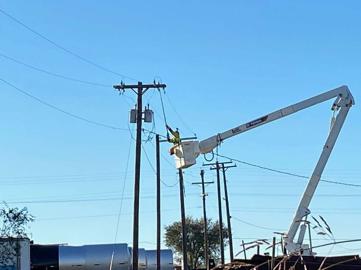 An AEP Texas worker is pictured fixing a power line. AEP Texas announced Friday that Laredo had the most power outages in Texas that day as all eyes in the state were on the Texas power grid during coming inclement weather.