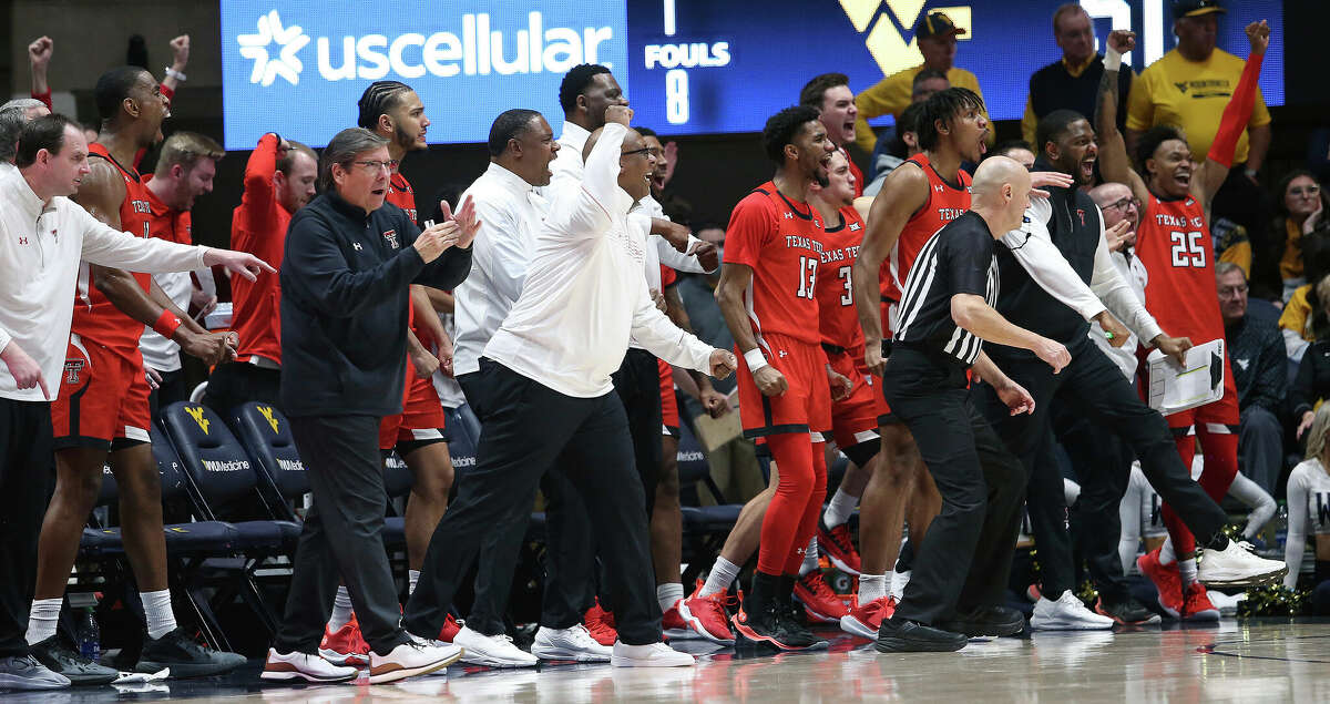 Texas Tech players and staff react during the second half of an NCAA college basketball game against West Virginia in Morgantown, W.Va., Saturday, Feb. 5, 2022. (AP Photo/Kathleen Batten)