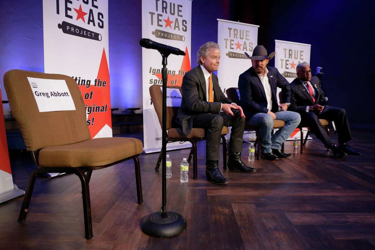 Republican candidates for governor, from left, Don Huffines, Chad Prather and Allen West take the stage with an empty prop chair for Gov. Greg Abbott during a debate held at Grace Woodlands Church by the True Texas Project Monday, Jan. 10, 2022 in Spring, TX.