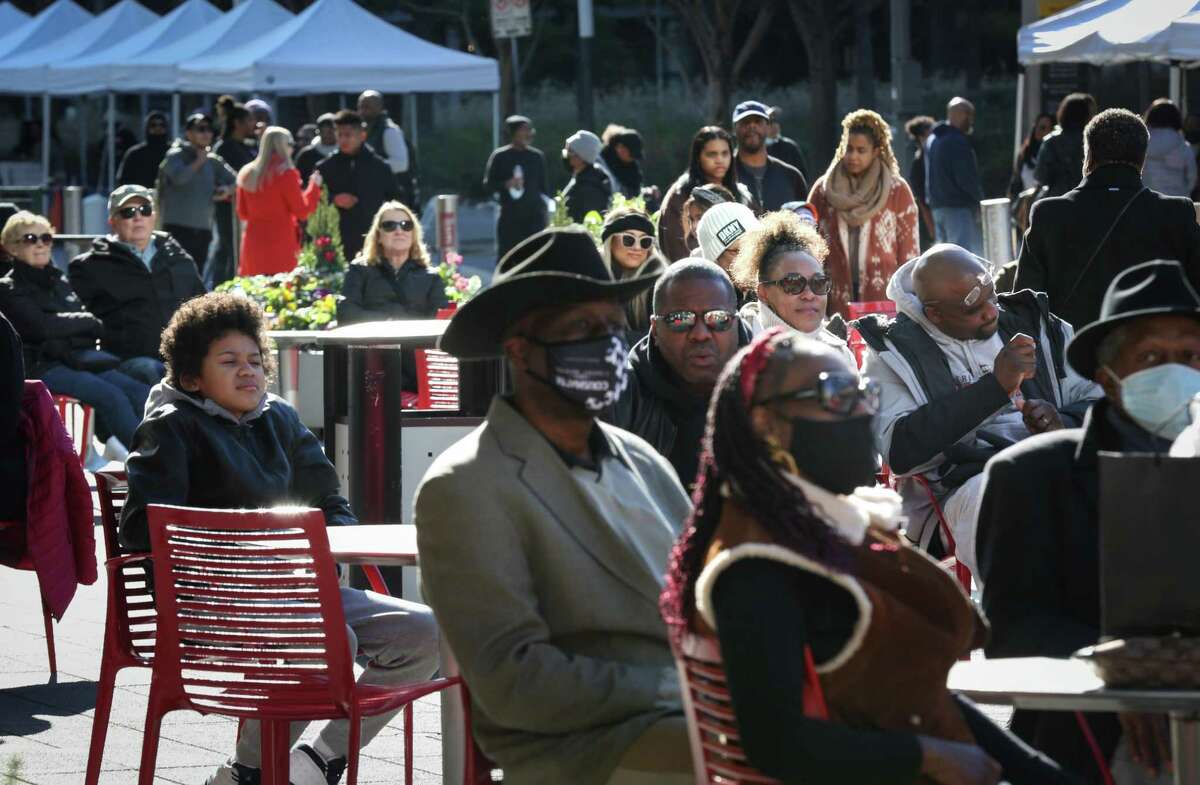 Ronald Thomas, center-right, and his wife Velika listen to a jazz performance during BLCK Market, an event to showcase Black-owned businesses, Saturday, Feb. 5, 2022, along Avenida De Las Americas in Houston. Ronald described he and his wife as “jazzaholics.”