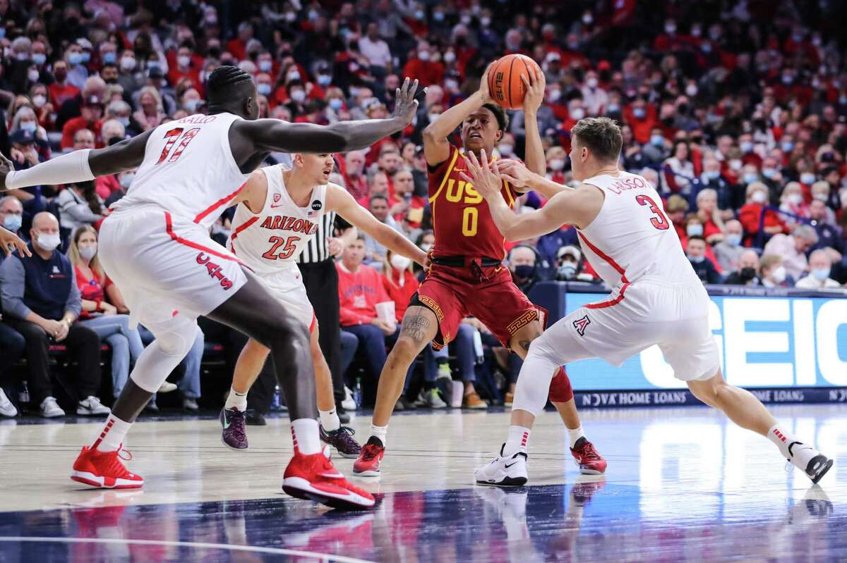 TUCSON, ARIZONA - FEBRUARY 05: Guard Boogie Ellis #0 of the USC Trojans looks for a route to the basket between center Oumar Ballo #11 of the Arizona Wildcats, guard Kerr Kriisa #25 of the Arizona Wildcats and guard Pelle Larsson #3 of the Arizona Wildcats during the first half of the NCAAM game at McKale Center on February 5, 2022 in Tucson, Arizona. The Arizona Wildcats lead 29-28 against the USC Trojans. (Photo by Rebecca Noble/Getty Images)