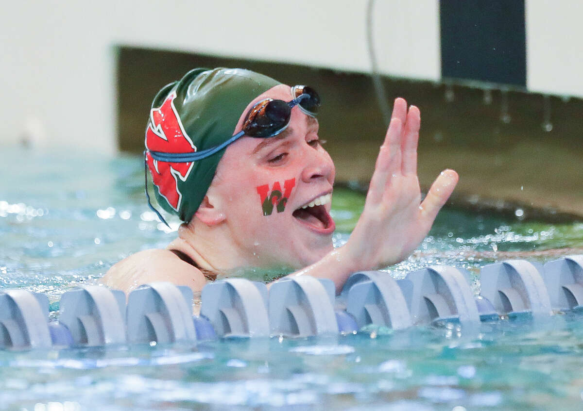 Mary Nordmann of The Woodlands reacts after competing in the girls 100-yard butterfly during the Region IV-6A Swimming & Diving Championships, Saturday, Feb. 5, 2022, in Shenandoah.