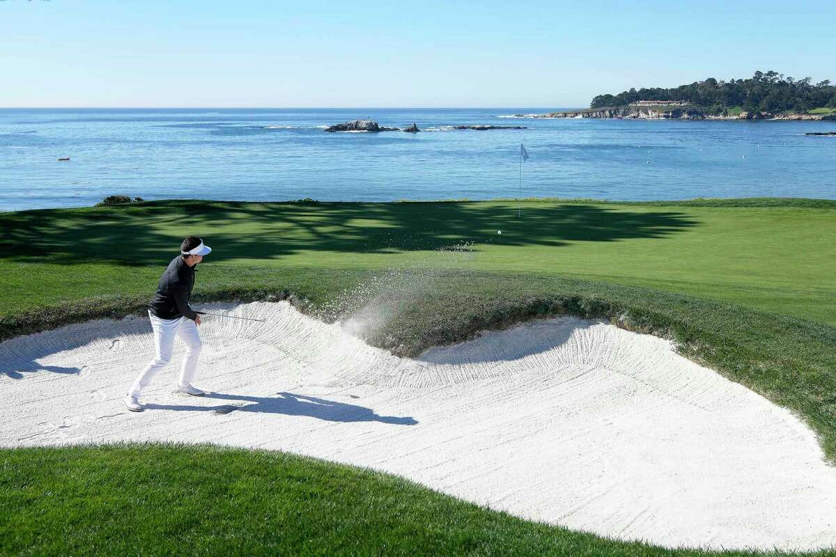 Beau Hossler hits out of a bunker onto the fourth green of the Pebble Beach Golf Links during the final round of the AT&T Pebble Beach National Pro-Am golf tournament in Pebble Beach, Calif., Sunday, Feb. 6, 2022. (AP Photo/Tony Avelar)