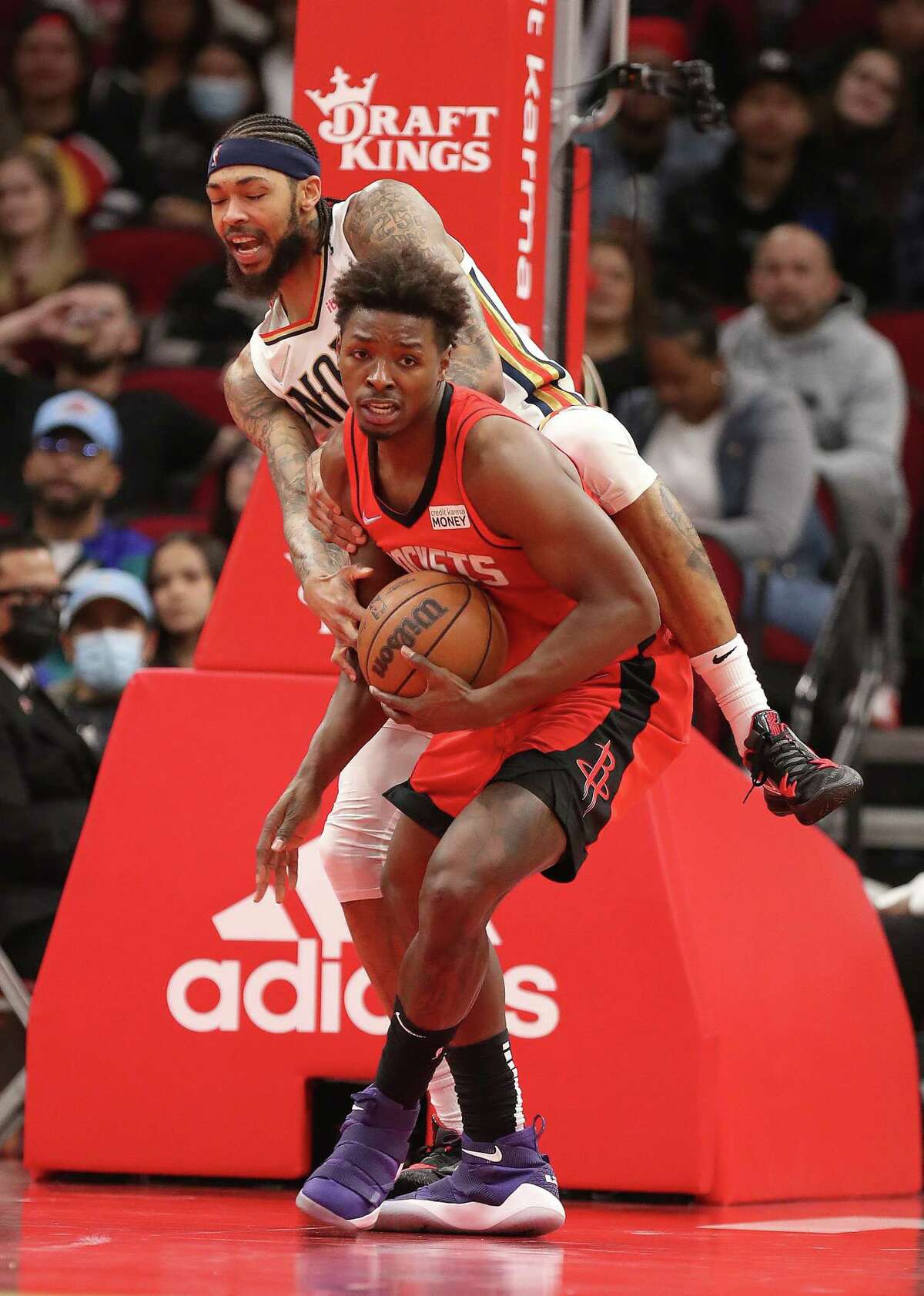 Houston Rockets forward Jae'Sean Tate (8) grabs a rebound against New Orleans Pelicans forward Brandon Ingram (14) during the second half of an NBA game at Toyota Center on Sunday, Feb. 6, 2022 in Houston.