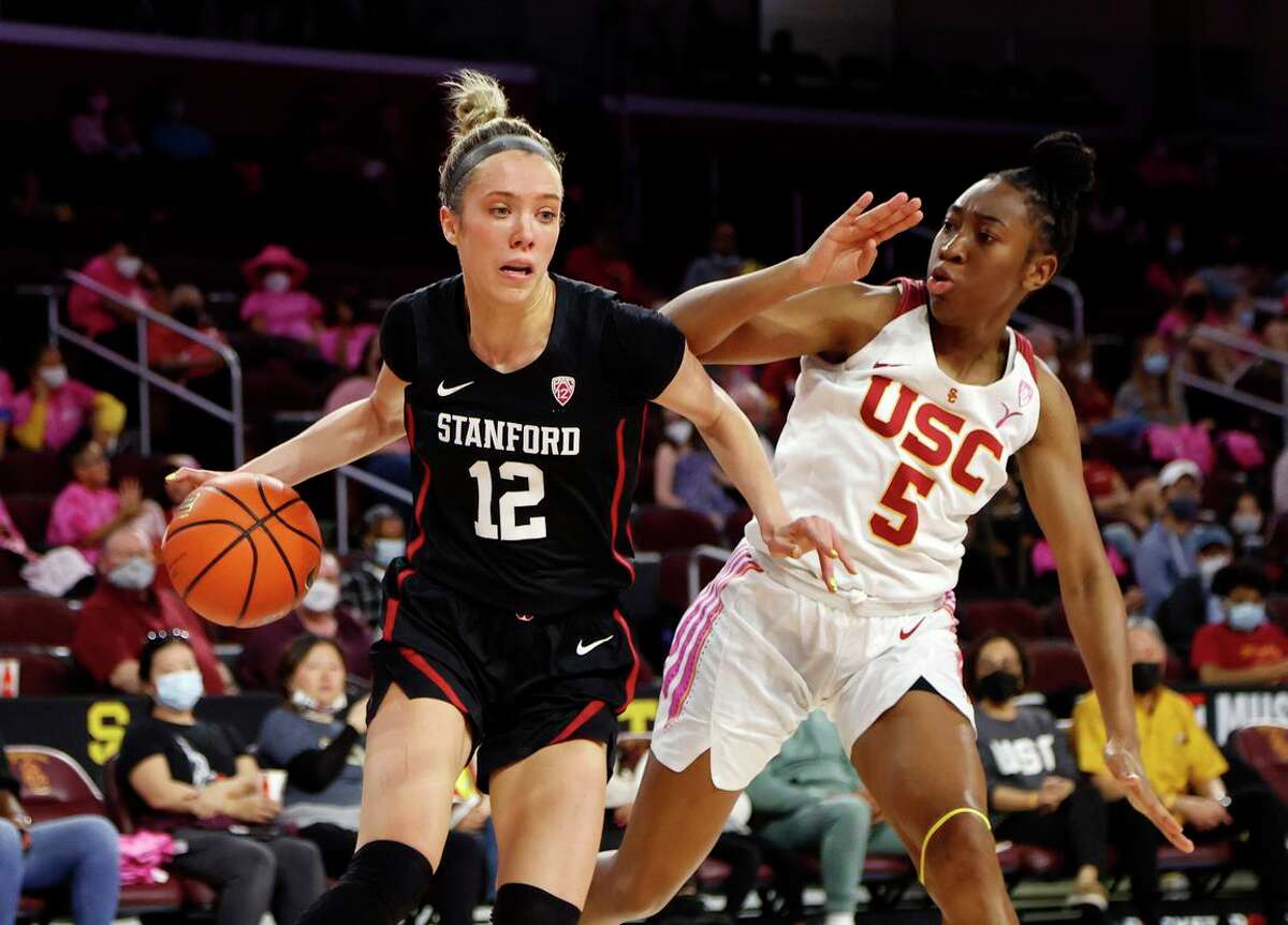 Stanford guard Lexie Hull drives past USC forward Jordan sanders in the first half. Hull contributed nine points and four assists as the Cardinal sprinted past the Trojans. Stanford extended its conference winning streak to 24 games.