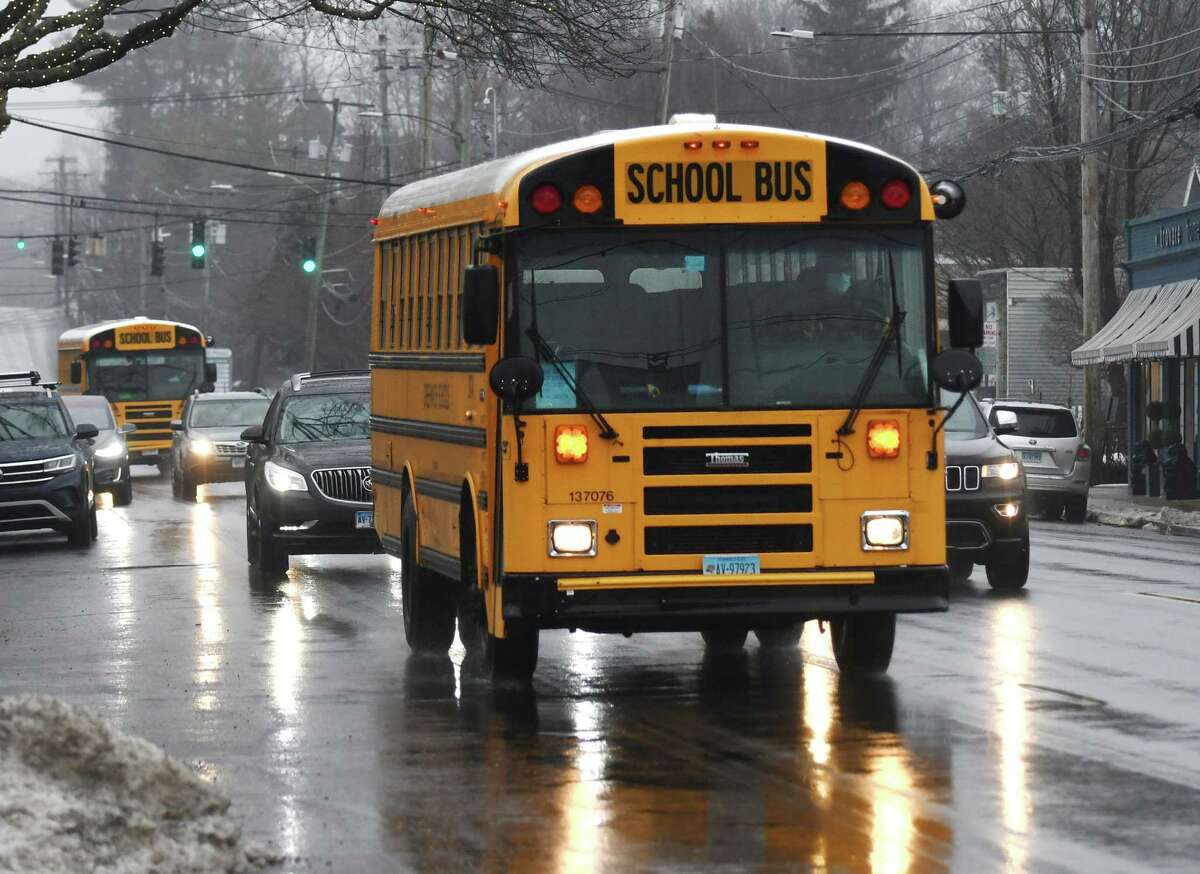 A Greenwich school bus drives through Cos Cob en route to pick up students at dismissal in Greenwich, Conn., photographed on Thursday, Feb. 3, 2022. Greenwich Public Schools’ operating budget is above what was requested and rising transportation costs are a big reason why.
