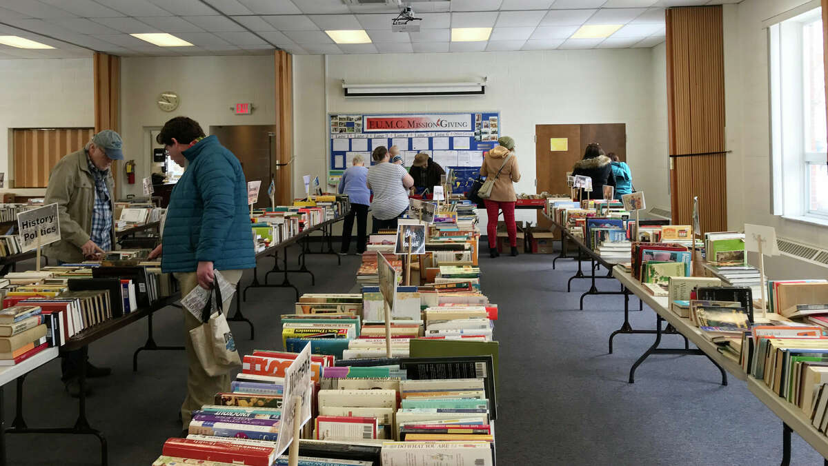 Shoppers browse the book stock from a previous year’s AAUW book sale. This year’s sale event, April 8-9, will feature an Author’s Corner where attendees will be able to meet local authors to discuss their work and the writing and publishing process.