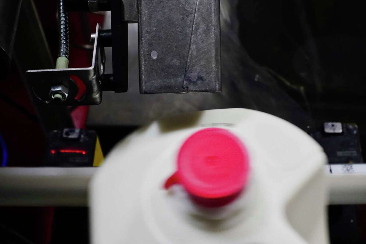An inkjet printer labels an expiration date onto a gallon of whole milk as it moves along the milk line at Battenkill Valley Creamery in Salem, N.Y.