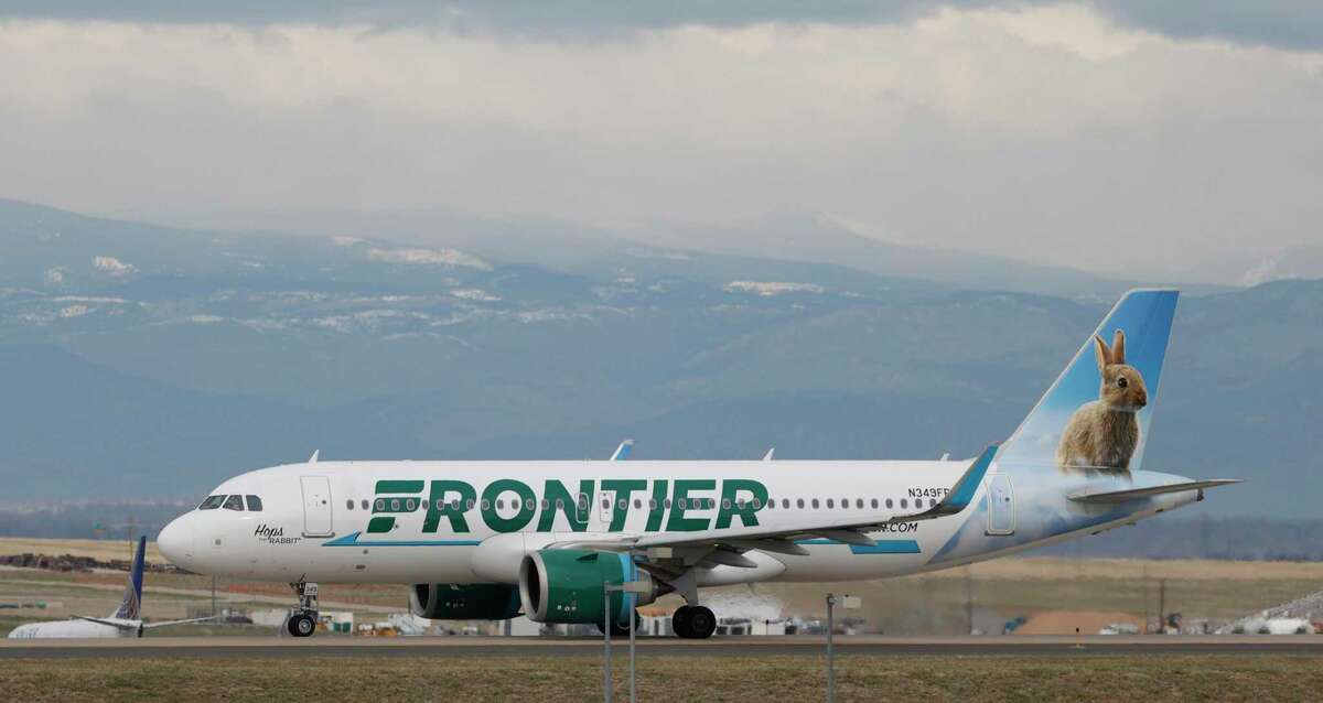 FILE - A Frontier Airlines jetliner taxis to a runway to take off from Denver International Airport Thursday, April 23, 2020, in Denver. Frontier Airlines' parent company is buying Spirit Airlines in a $2.9 billion cash-and-stock deal that will allow the combined airline to be more competitive against its larger rivals.