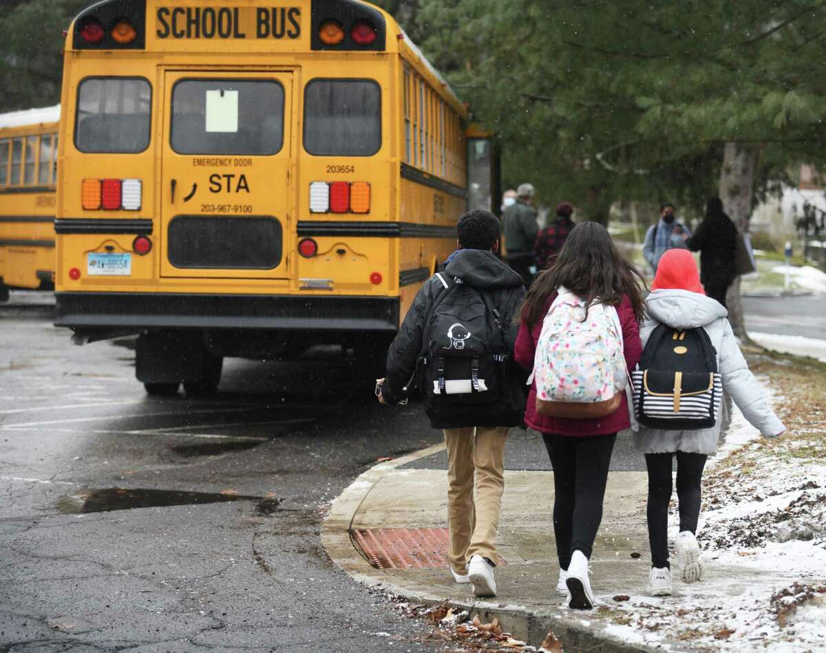 Central Middle School students board shuttle buses to different schools from Central Middle School in Greenwich, Conn. Monday, Feb. 7, 2022. Due to safety issues, Central Middle School is closed this week. For the time being, CMS sixth-graders will attend school at Cos Cob School, seventh-graders at Eastern Middle School, and eighth-graders at Greenwich High School.