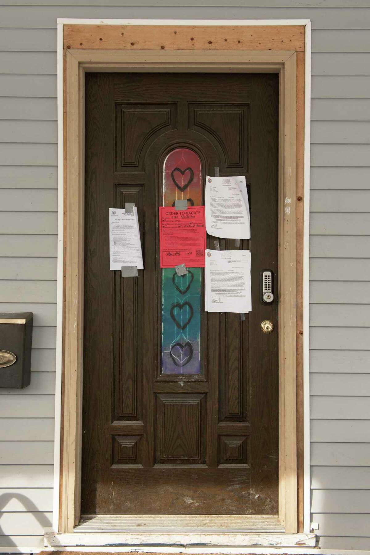 City vacate papers are seen on the front door of 1121 McClellan St. on Monday Feb. 7, 2022 in Schenectady, N.Y. Emergency workers descended on this home to find a a dead woman and several children amid horrific conditions inside.