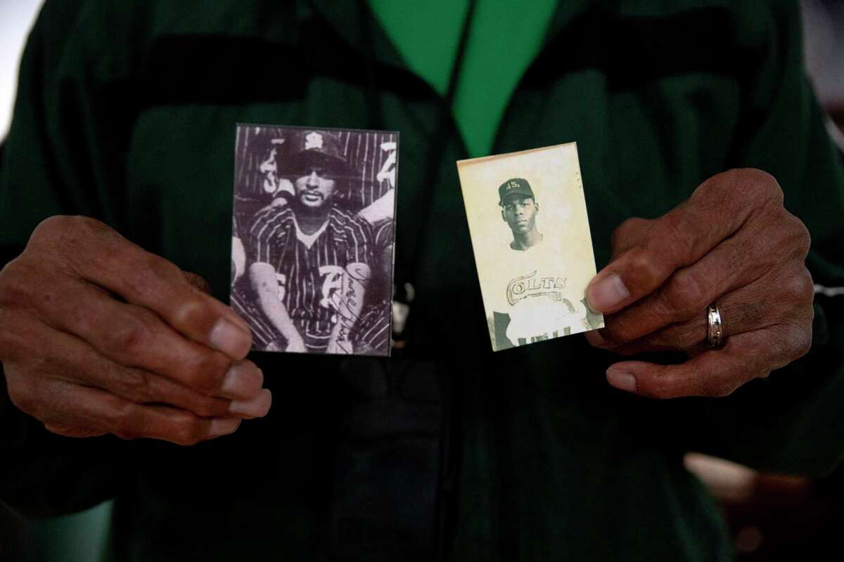 Former Negro League Baseball player Lawrence “Ditney” Johnson holds a photo of his late brother (right), Elijah Johnson, a standout batter in the minor baseball leagues at the Triple-A level, and a photo of himself (left). Both brothers played baseball since they were children.